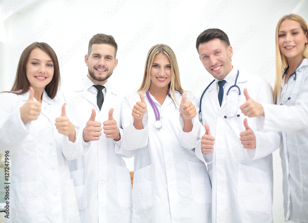 Portrait of happy doctors team showing thumbs up Portrait of happy doctors team showing thumbs up
