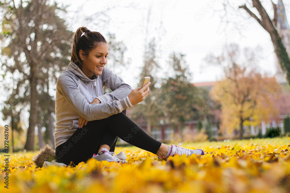 Break from training in park, checking messages Break from training in park, checking messages