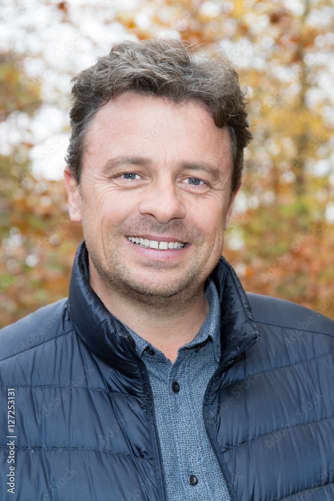 Portrait of man standing outside in autumn landscape Portrait of man standing outside in autumn landscape
