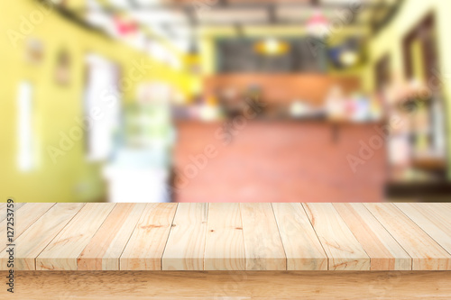Empty top of wood table with blur interior coffee shop background.