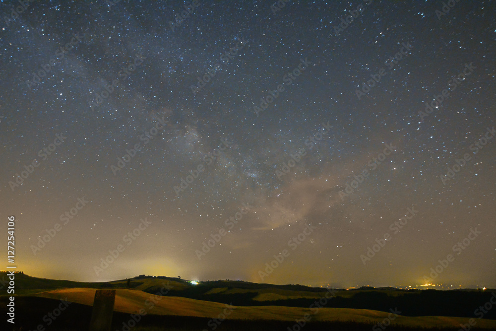 View of a starry night of a tuscan countryside near Siena View of a starry night of a tuscan countryside near Siena