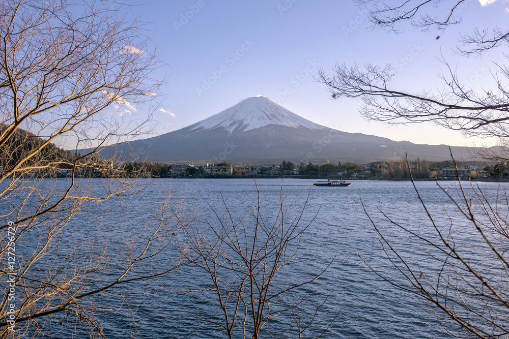 Japan, Fuji mountain, Kawaguchiko lake in autumn afternoon, With warm sunlight effect created reflection highlight shadow at the mountain, land, lake and building.