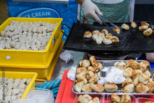 Street food : Crispy fried dumpling in hot pan fry at the night market