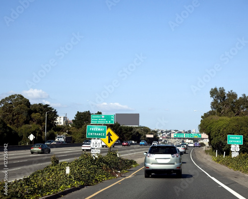 Slika na platnu Merging traffic onto entrance freeway. Blue sky. Horizontal.