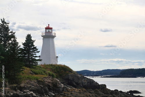 The lightstation  light house now museum  at Green   s Point  is octagonal wooden tower established in 1879 and altered in 1903 to direct boats and ships traffic trough LEtete Passage Bay of Fundy.