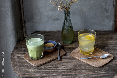 Two cups of matcha latte with latte art on black table. Top view.Alcoholic Gin and Tonic with a Lime Garnish