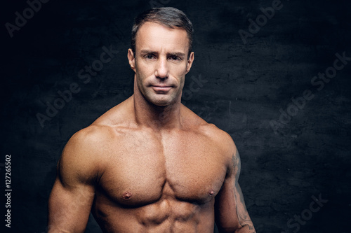 Portrait of muscular shirtless positive middle age male. © Fxquadro