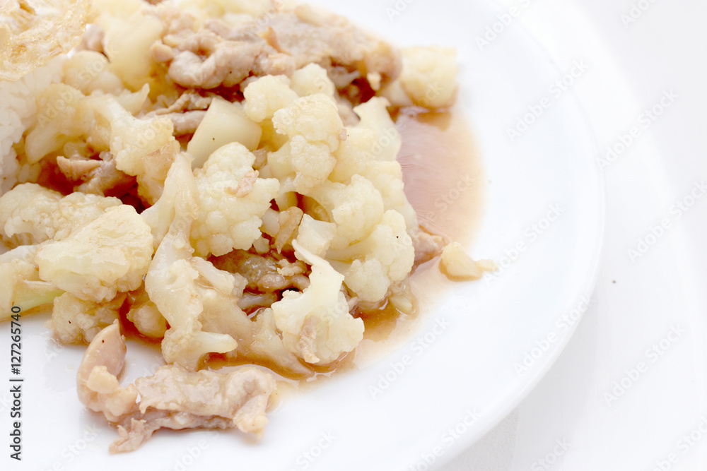 Fried cauliflower with pork, fried eggs with rice in white dish isolate on white background, Thai style food Fried cauliflower with pork, fried eggs with rice in white dish isolate on white background, Thai style food