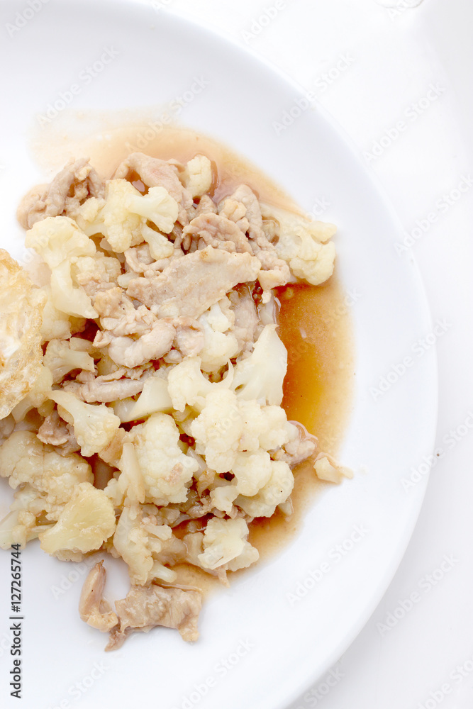 Fried cauliflower with pork, fried eggs with rice in white dish isolate on white background, Thai style food Fried cauliflower with pork, fried eggs with rice in white dish isolate on white background, Thai style food