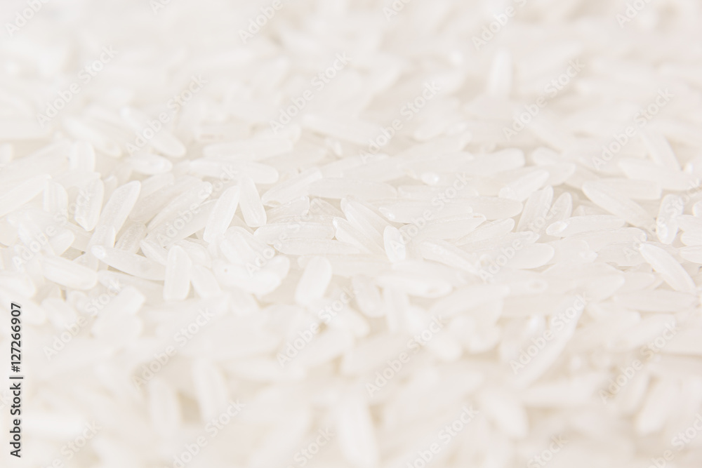 White jasmine rice close-up background. Heap polished long rice for vegetarians.