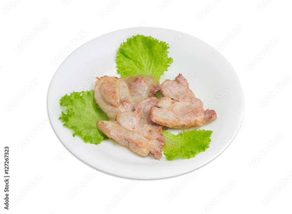 Fried pork on lettuce leaves on white dish