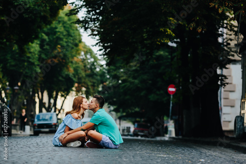 couple sitting on pavement square