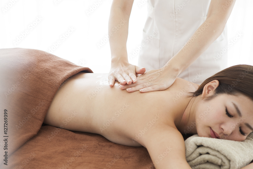 Beautiful Asian women who are receiving massage on their back Beautiful Asian women who are receiving massage on their back