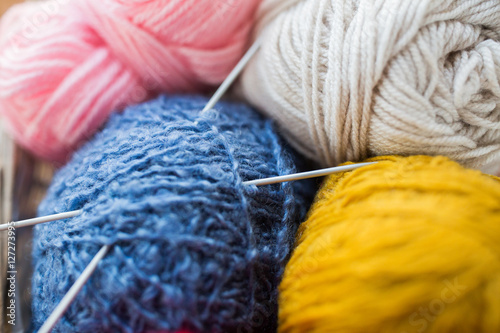 close up of knitting needles and yarn balls