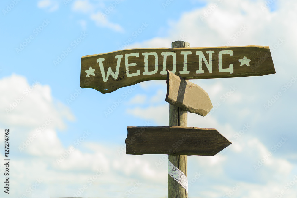 Fototapeta premium Wedding wooden sign on sky background