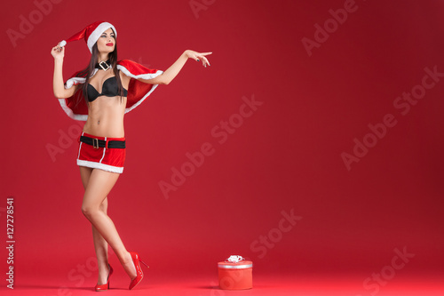 sexy women in the clothes of Santa Claus with Christmas gift