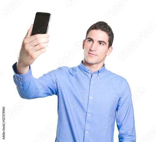 Confident young man taking a selfie with his smartphone