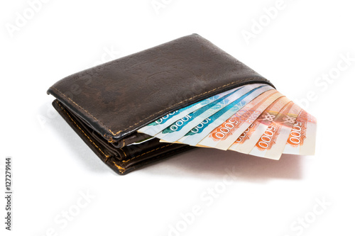 Old leather brown wallet with one thousand and five thoushand rubles banknotes isolated on white background