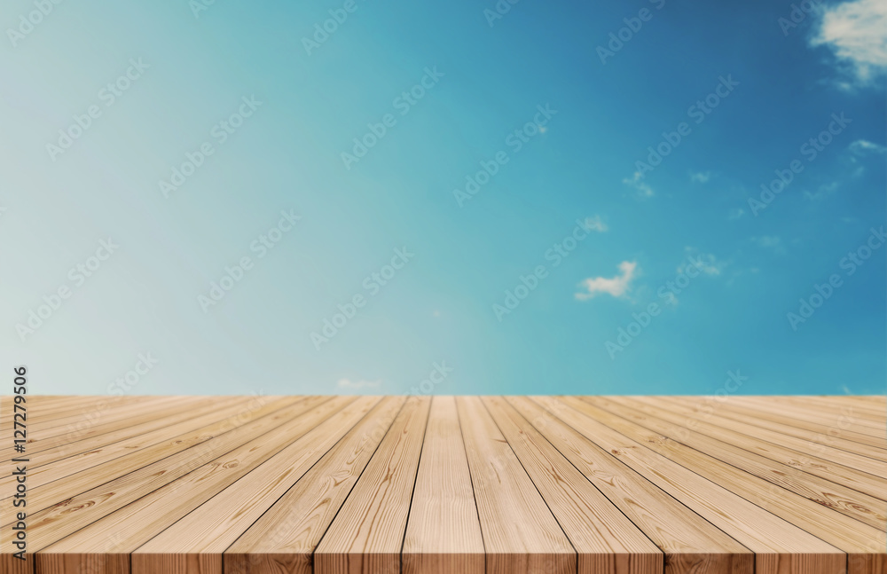 Wood table top on gradient blue sky and white clouds background. also used for display or montage your products