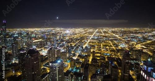 Chicago, Illinois, USA - view from observatory of John Hancock Center of illuminated City with Willis Tower (formerly Sears Tower) facing southwest at night - Timelapse with zoom out 
