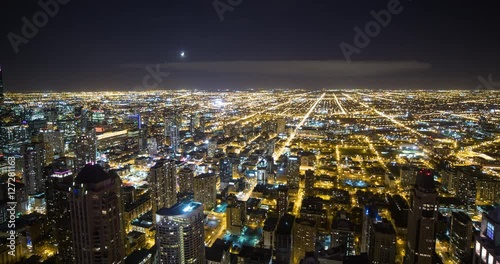 Chicago, Illinois, USA - view from observatory of John Hancock Center of illuminated City with Willis Tower (Sears Tower) facing southwest at night - Timelapse with pan right to left