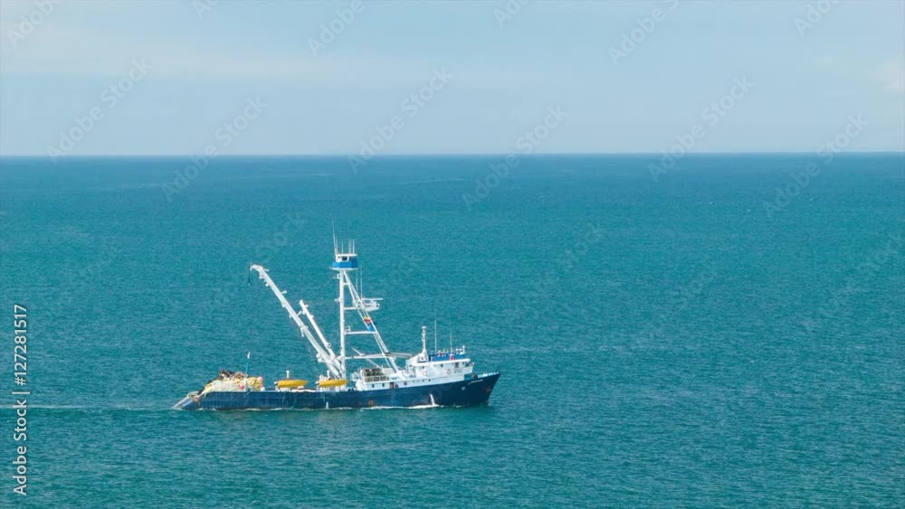 Big Blue Open Pacific Ocean with Fishing Boat Following Close-up Shot on a Sunny Day near Manta Ecuador