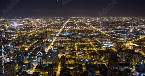 Chicago, Illinois, USA - view from the observatory of the John Hancock Center of illuminated City facing west at night - Timelapse with pan left to right
