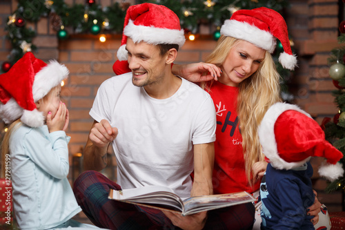 Smiling family in Santa hats