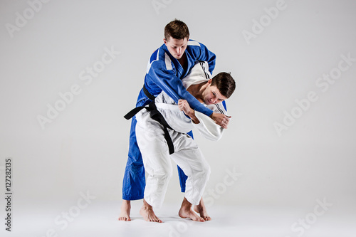 The two judokas fighters fighting men