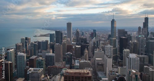 Chicago, Illinois, USA - view from the observatory of the John Hancock Center at City along Michigan Avenue with Tribune and Trump Tower at sunset - Timelapse with pan right to left 