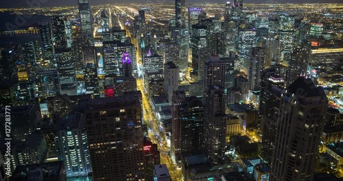 Chicago, Illinois, USA - view from the observatory of the John Hancock Center of illuminated City facing south at night - Timelapse with zoom out