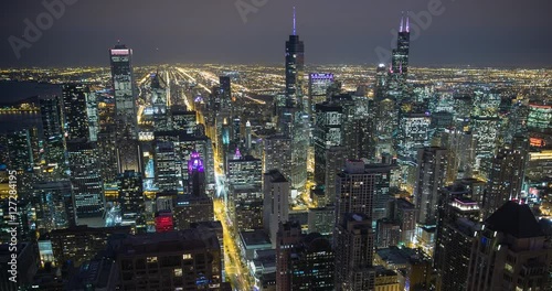 Chicago, Illinois, USA - view from the observatory of the John Hancock Center of illuminated City facing south at night - Timelapse with pan left to right 
