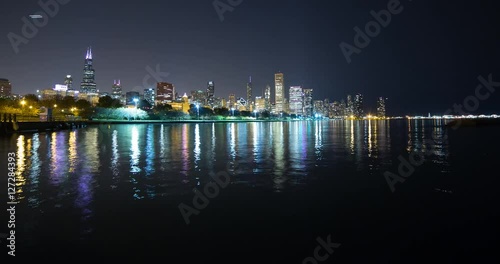 Chicago, Illinois, USA - view from the Lakefront Trail at the Field Museum / Shedd Aquarium facing north at shore of Lake Michigan and skyline at night - Timelapse with pan right left 