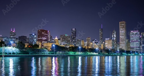 Chicago, Illinois, USA - view from the Lakefront Trail at the Field Museum / Shedd Aquarium facing north at shore of Lake Michigan and skyline at night - Timelapse with pan left right 