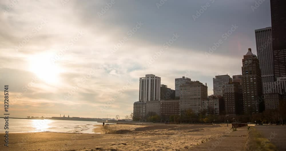 Chicago, Illinois, USA - view from Oak Street Beach to John Hancock Center after sunrise with clouds and colorful sky at the shore of Lake Michigan - Timelapse with pan left to right Chicago, Illinois, USA - view from Oak Street Beach to John Hancock Center after sunrise with clouds and colorful sky at the shore of Lake Michigan - Timelapse with pan left to right