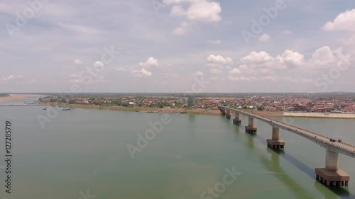 Wallpaper Mural aerial drone shot : Panning shot of vehicles crossing the long concrete bridge over a river. Torontodigital.ca