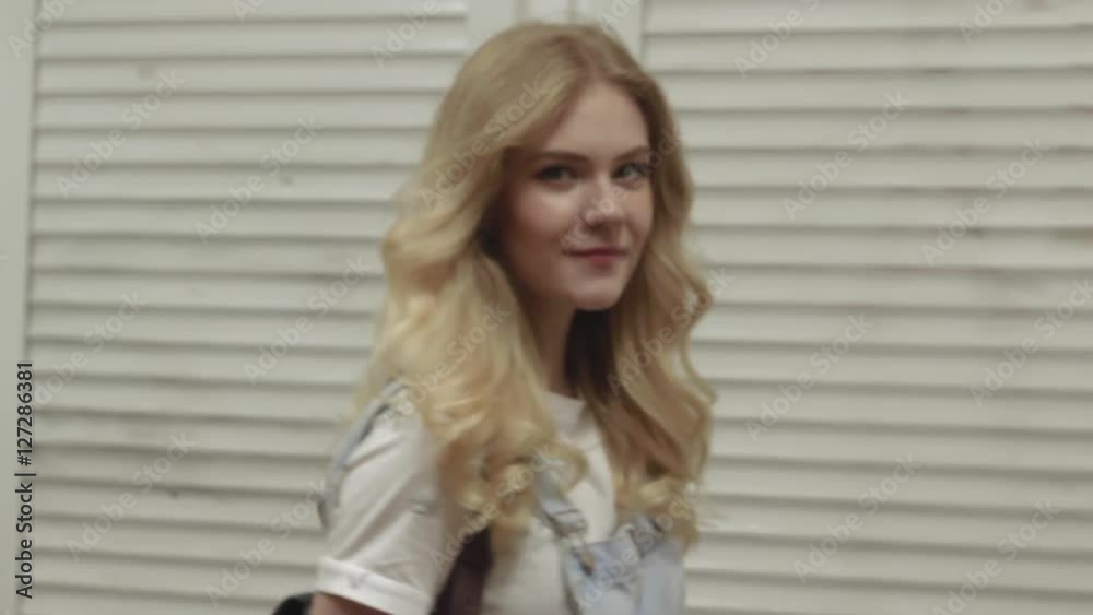 Young blonde beautiful girl walking and smiling in the underpass tunnel at night city Young blonde beautiful girl walking and smiling in the underpass tunnel at night city