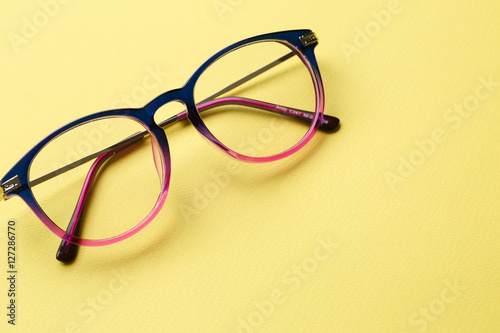 Blue-pink glasses on yellow background