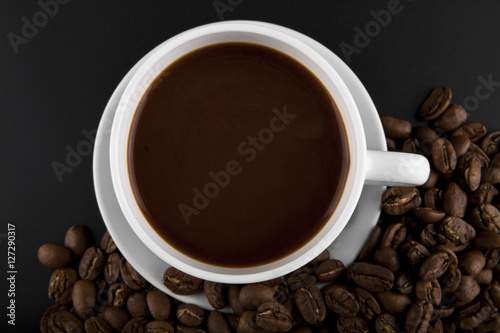 cup with hot coffee and grains