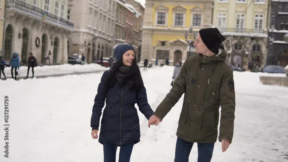 Young teenagers couple city walking in winter time Young teenagers couple city walking in winter time