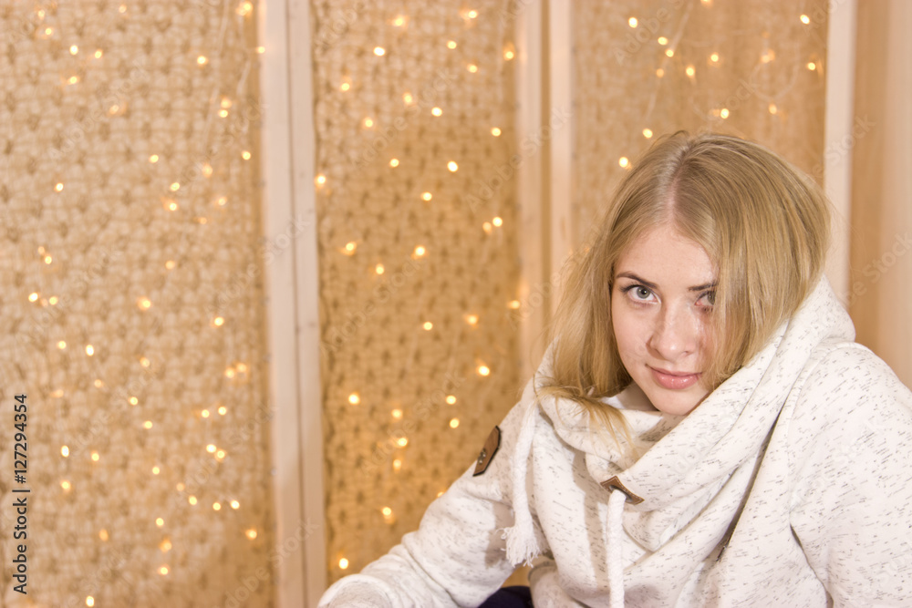 Fototapeta premium Girl on the background of Christmas garland.