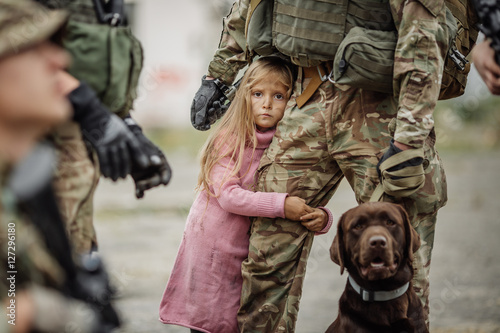 Billede på lærred Soldier and children on battlefield background.