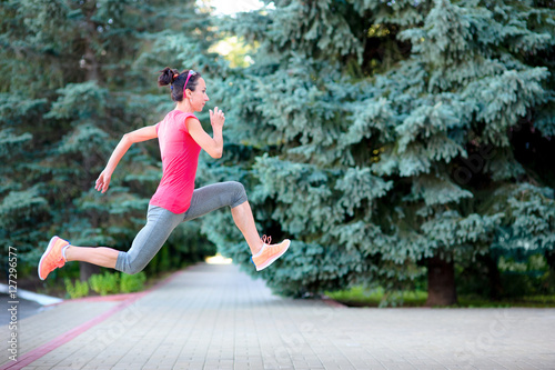 athlete woman running and jumping in training. Female urban athl