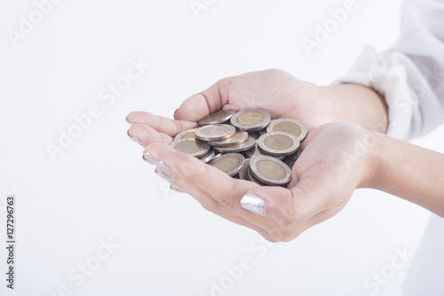 business hand holding coin money. concept saving finance and investment.