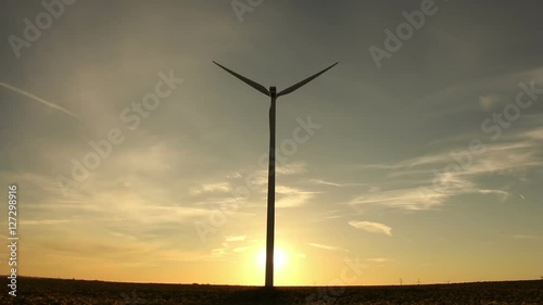 The Start Of Clean Power Generation Concept. Wind Turbines At Sunrise / Sunset photo