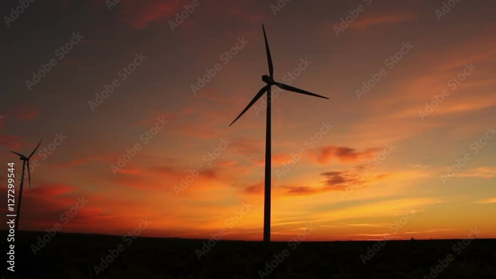 The Start Of Clean Power Generation Concept. Wind Turbines At Sunrise / Sunset The Start Of Clean Power Generation Concept. Wind Turbines At Sunrise / Sunset