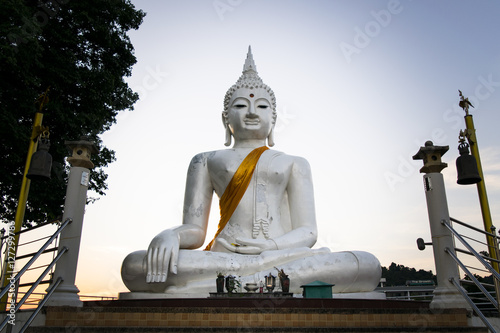 Fotografie The White buddha status on blue sky background in Thailand