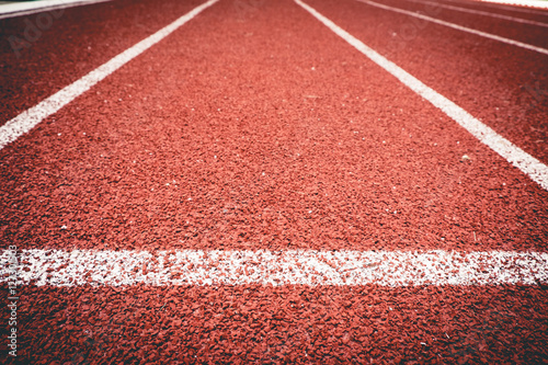 Fototapeta Naklejka Na Ścianę i Meble -  Close up line curve rubber running track standard.Vintage or retro tone.