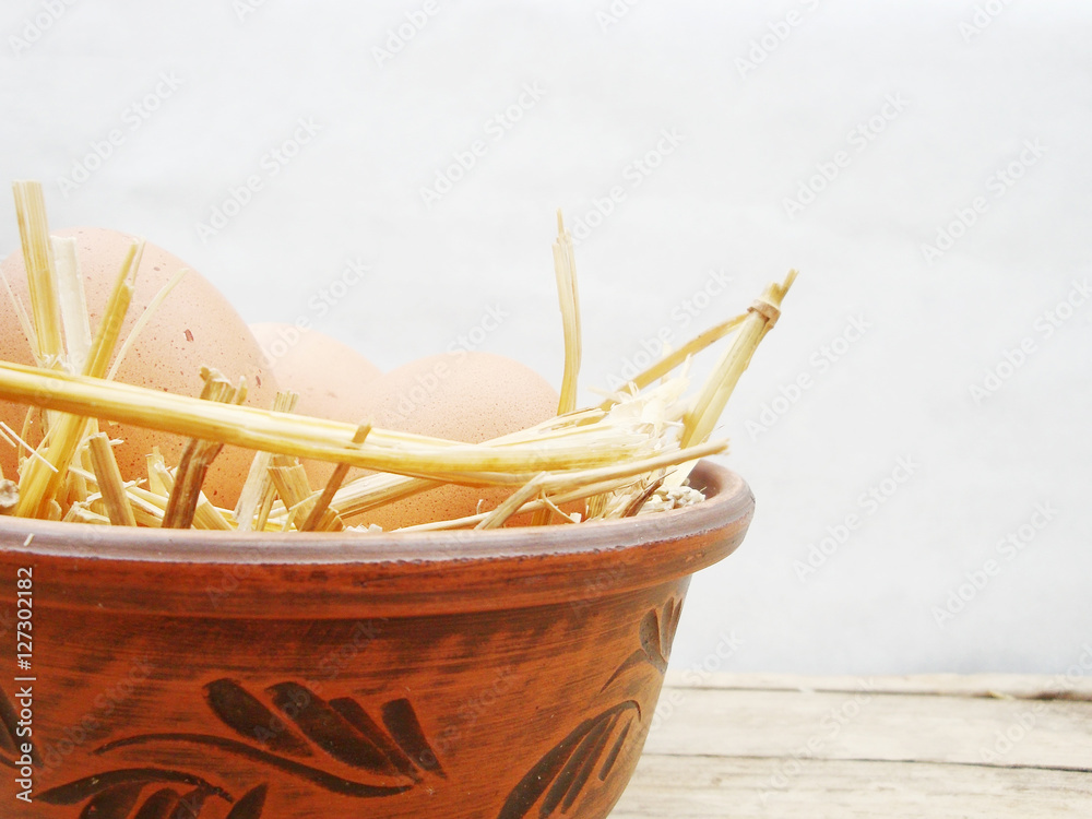 Fototapeta premium Chicken eggs in the straw