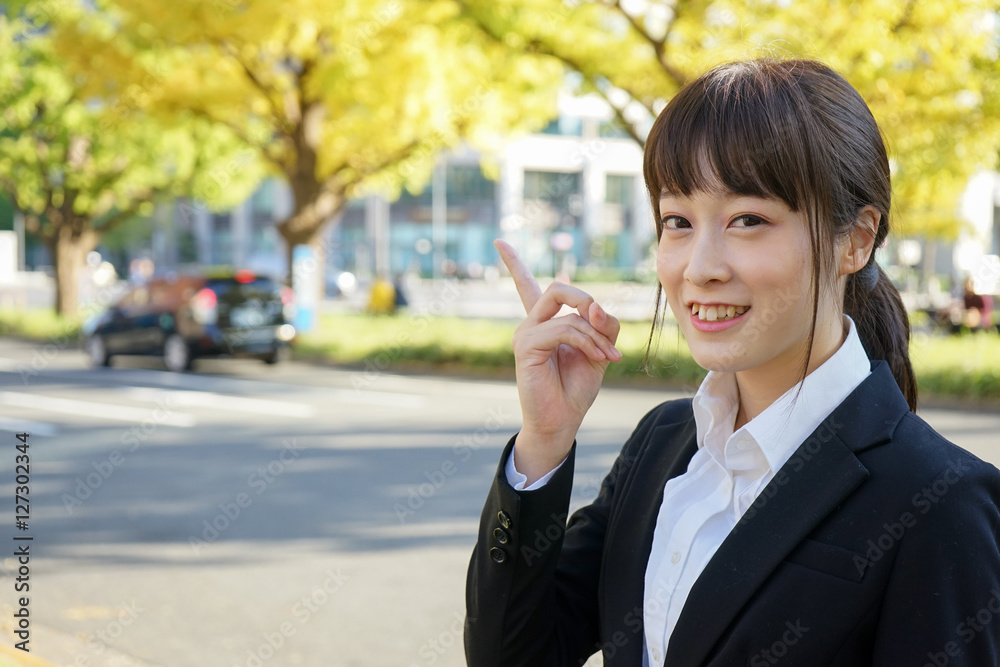 Young business woman pointing something with smile Young business woman pointing something with smile